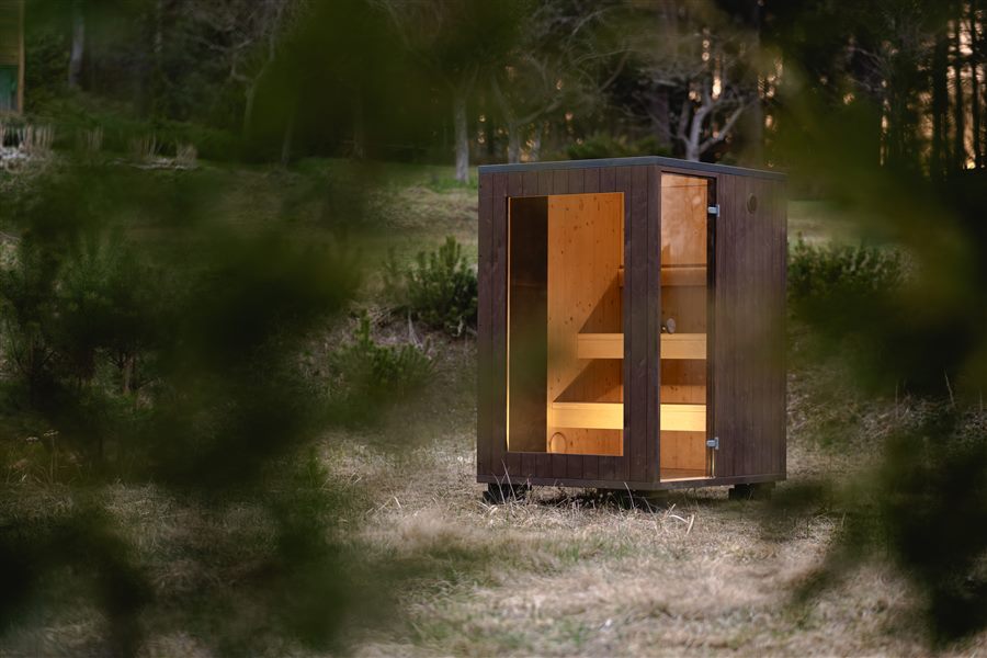 ROYAL S compact outdoor sauna cabin with grey exterior and full-height glazing